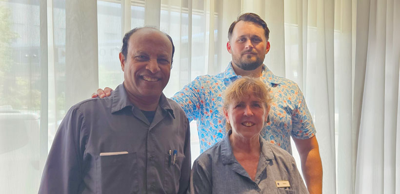 Negotiating committee members at DoubleTree by Hilton in London pose for a photo.